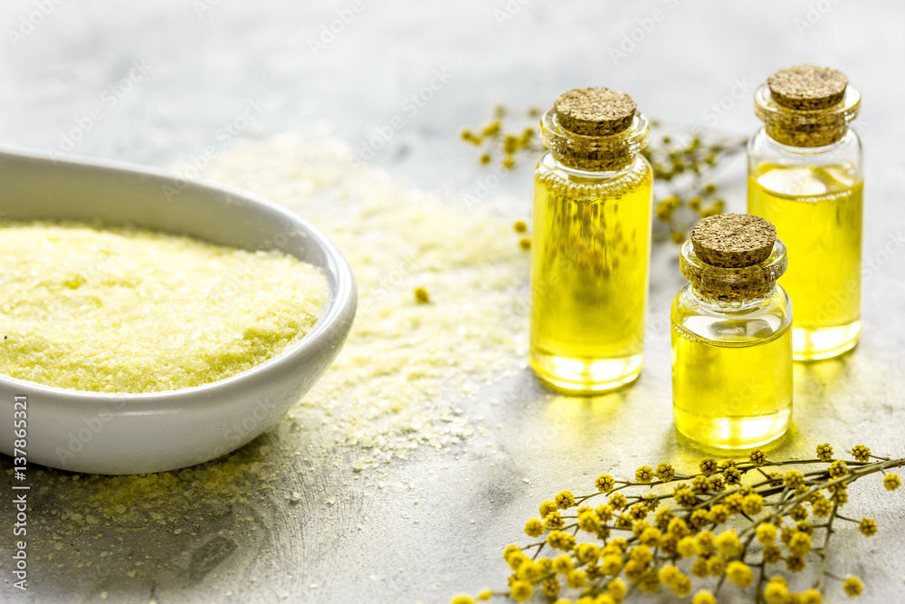 Natural cosmetic set with bath salt and organic oil on gray background