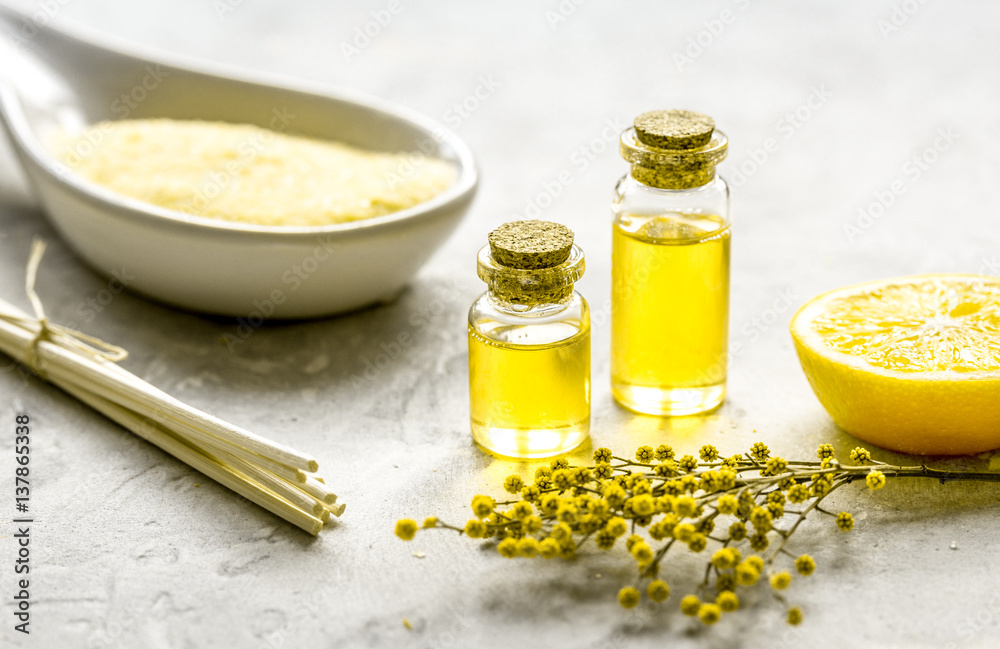 Natural cosmetic with bath salt and organic oil on gray background