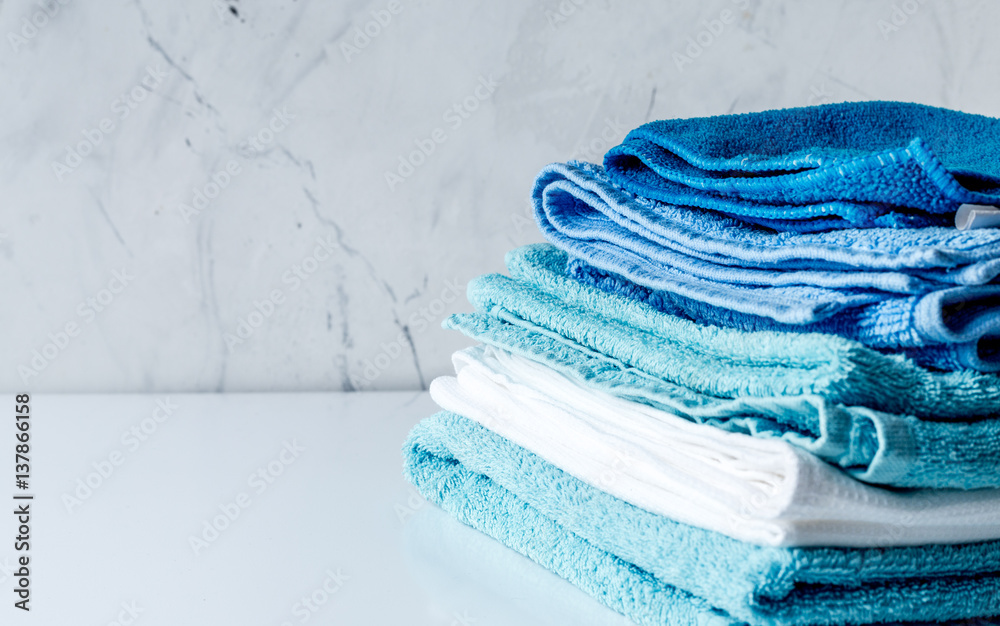 Towels pile in housekeeping set on laudry background mock up