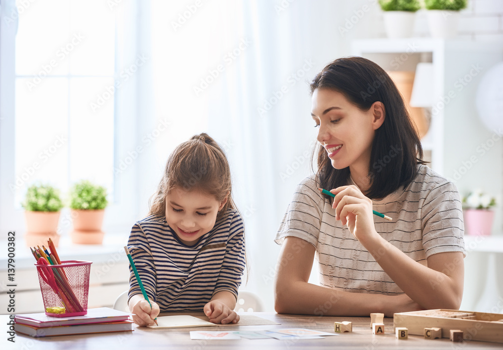 woman teaches child the alphabet