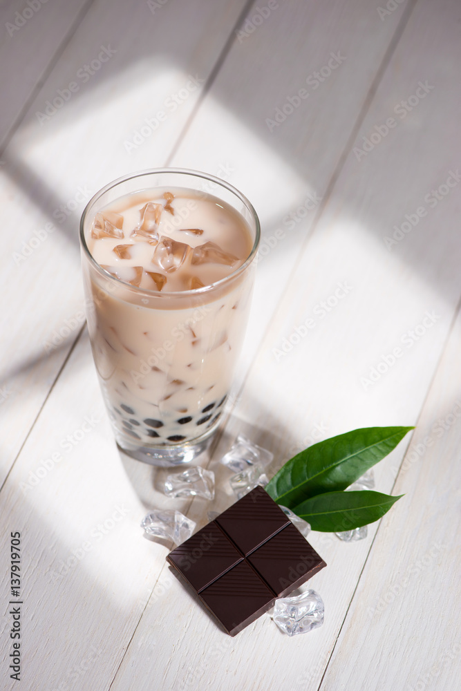 Bubble tea. Homemade Chocolate Milk Tea with Pearls on wooden table.