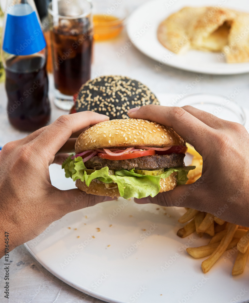 Man eating burgers