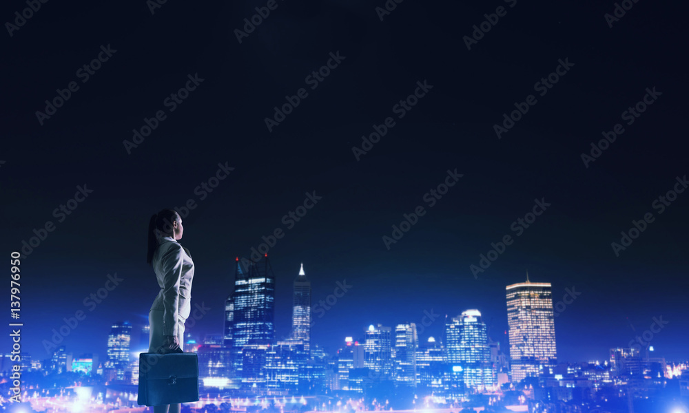 Woman looking at night city