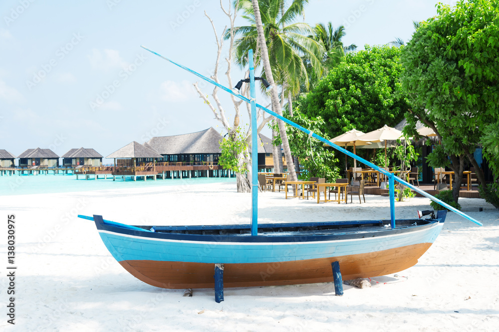 sail boat on beautiful tropical beach in blue sunny sky