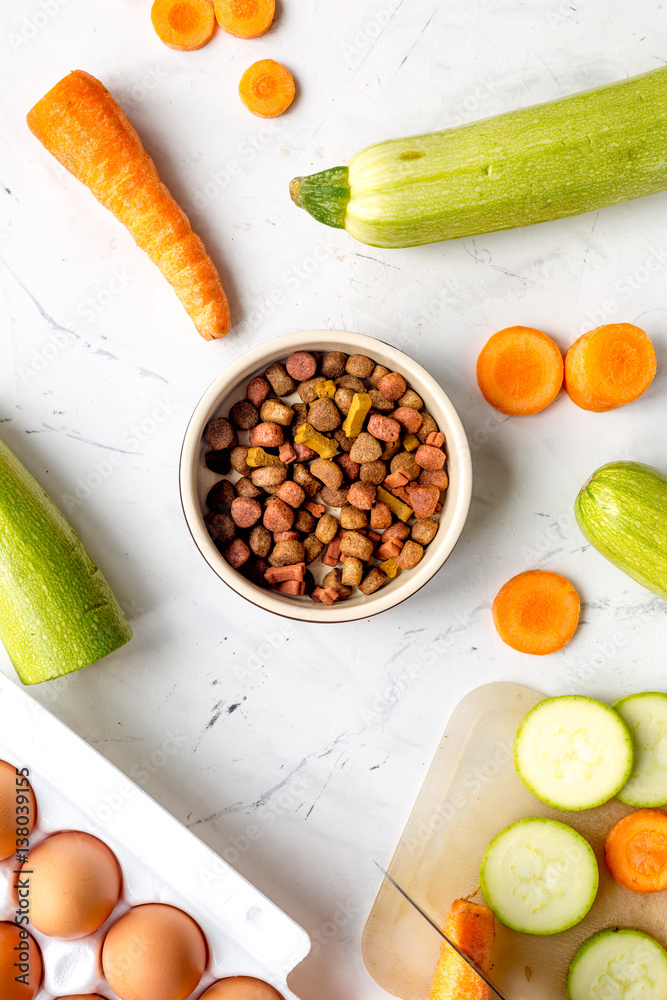 Vegetables and petfood on kitchen table background top view