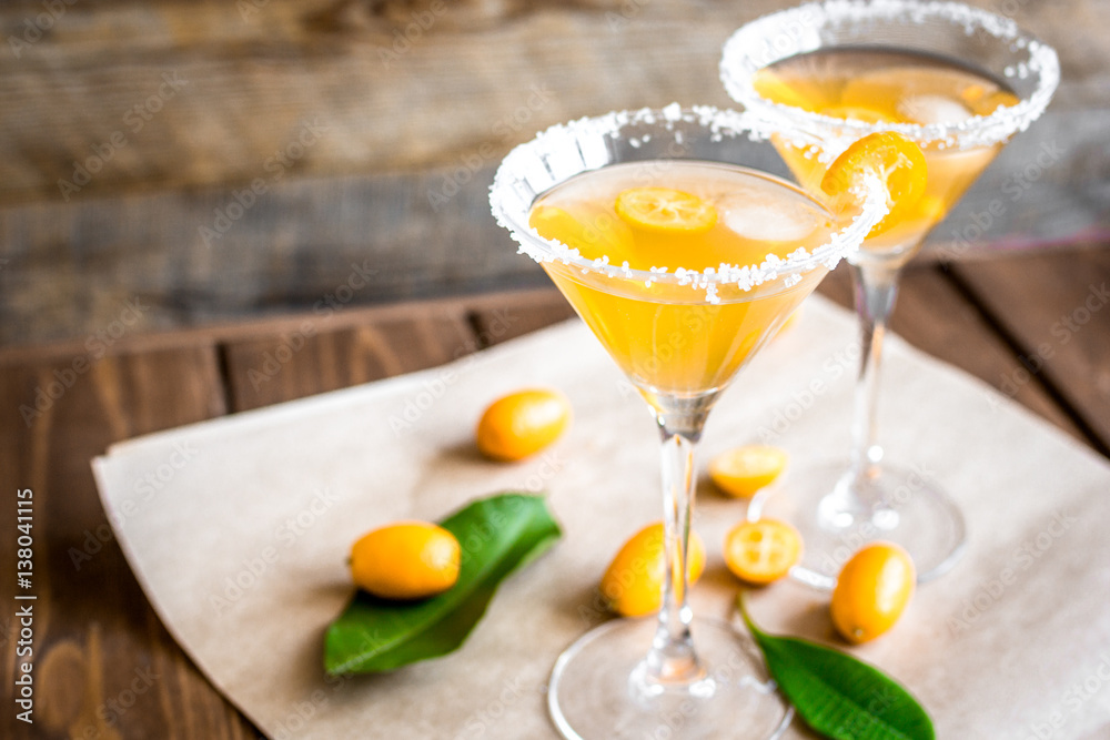 cocktail with kumquat on wooden background