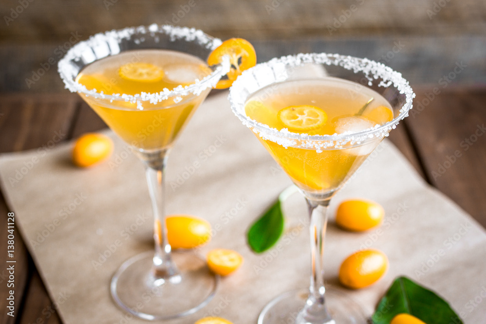 cocktail with kumquat on wooden background