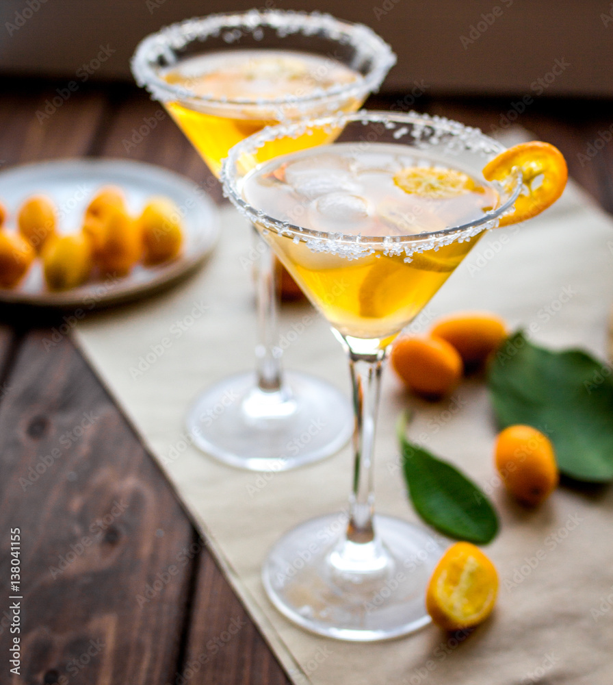 cocktail with kumquat on wooden background