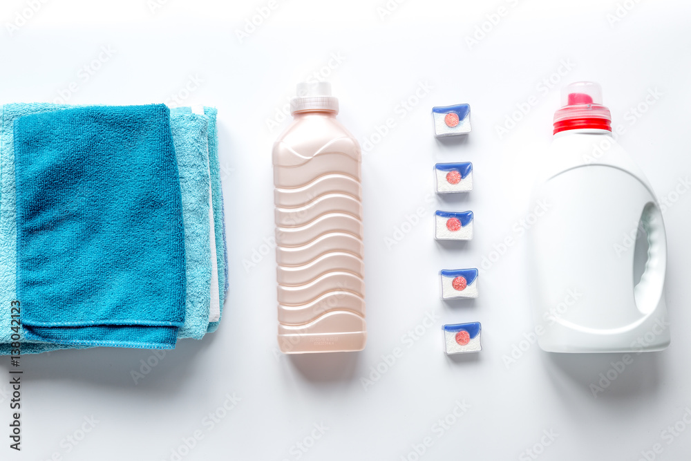 laundry set with towels and plastic bottels on white background top view