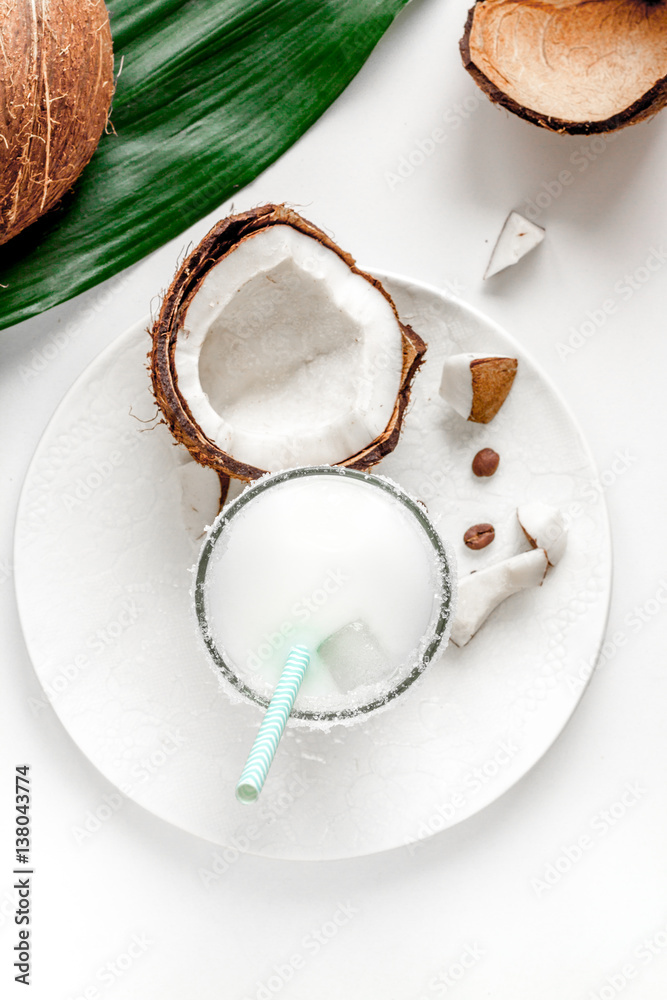 cocktail with coconut on white background top view