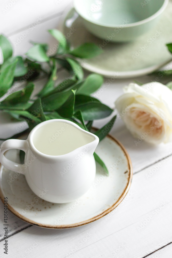 ceramic tableware with flowers on white background