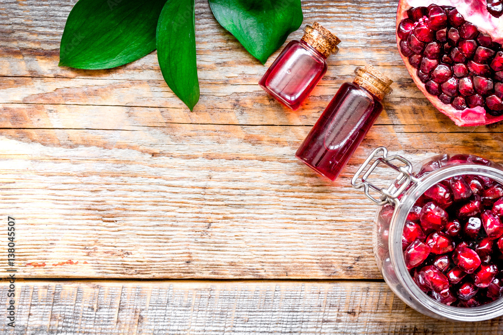 sliced pomegranate on wooden background top view