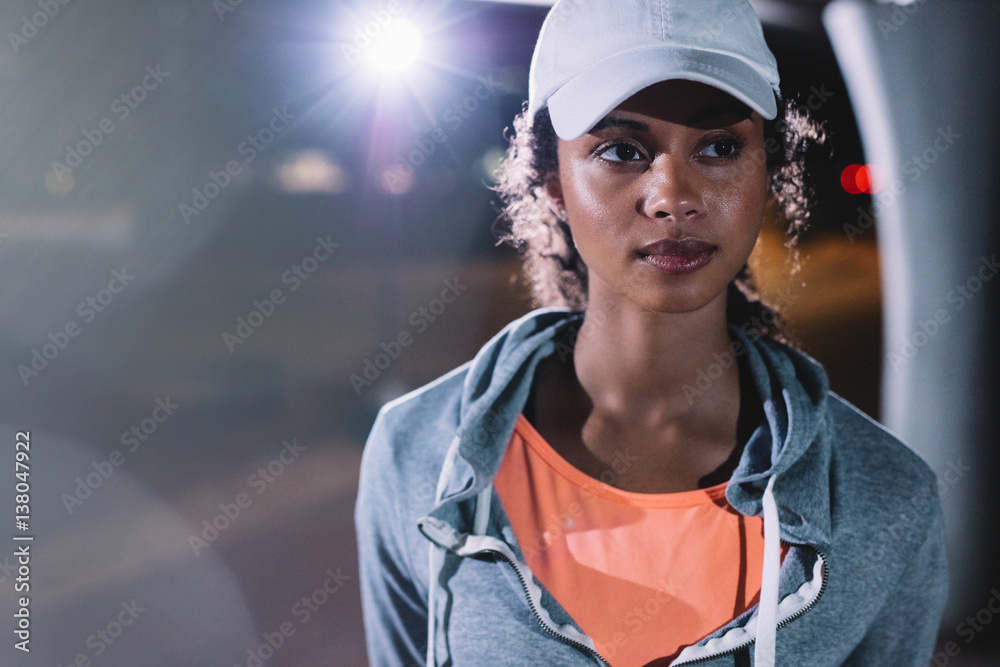 Beautiful fitness woman in the city at night