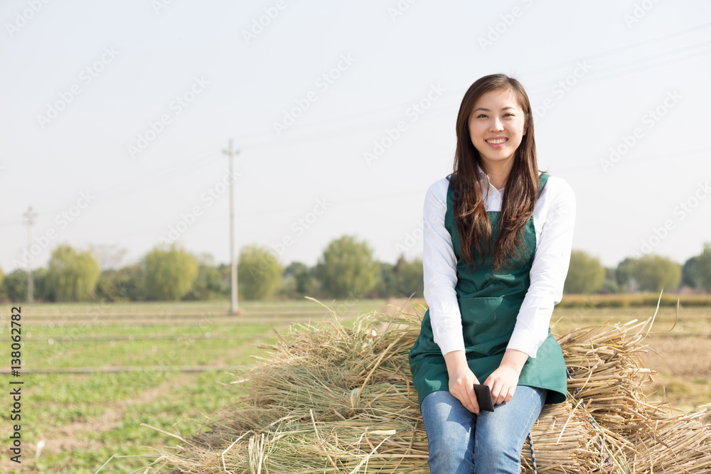 young asian woman agronomist in golden field