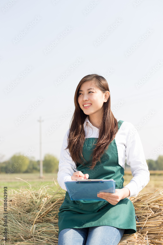 young asian woman agronomist in golden field