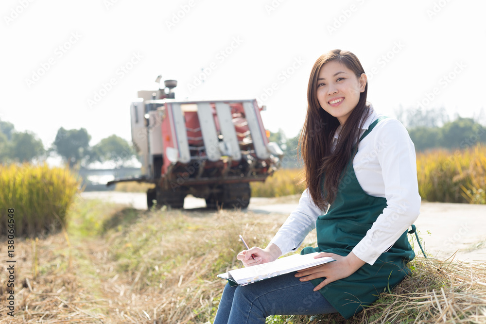 young asian woman agronomist in golden field