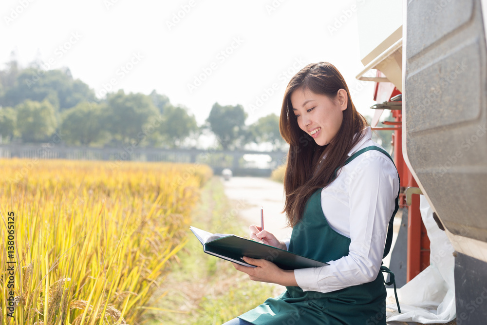 young asian woman agronomist in golden field