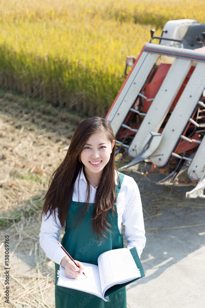 young asian woman agronomist in golden field