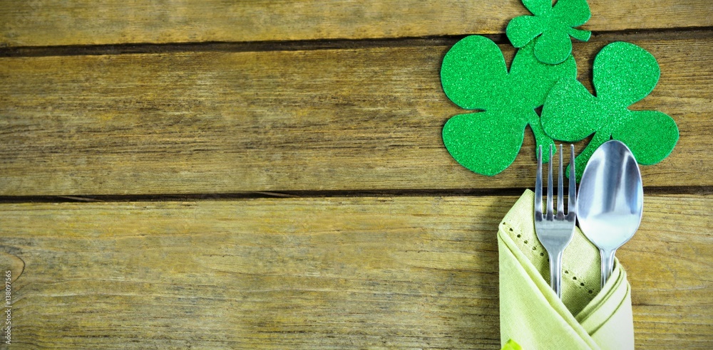 St Patricks Day fork and spoon wrapped in napkin with shamrocks