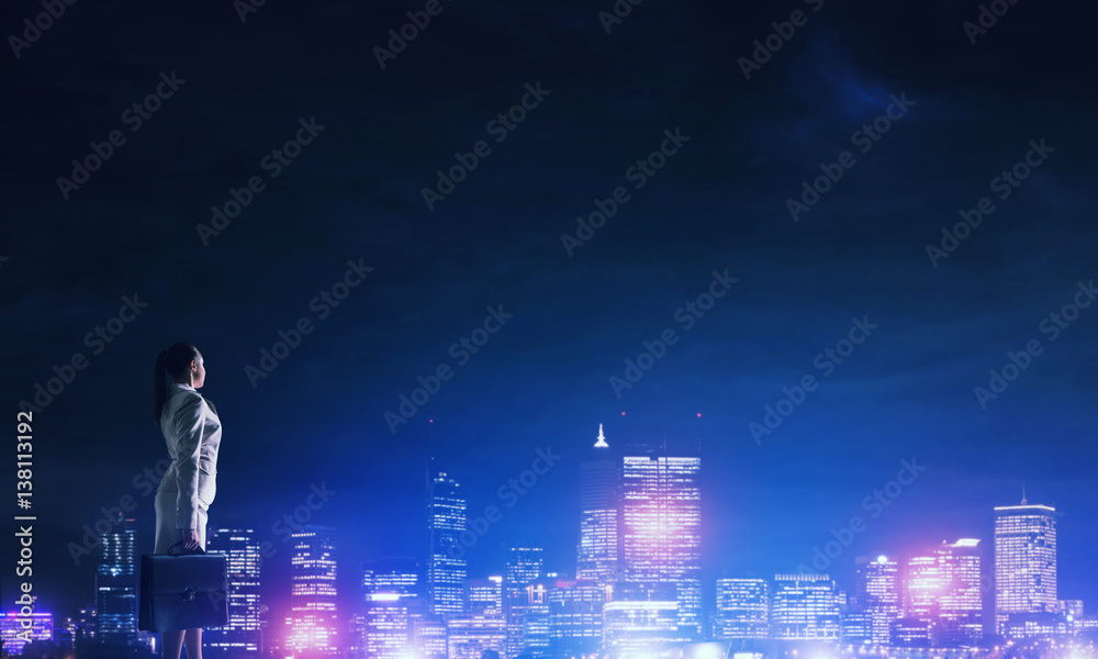 Woman looking at night city