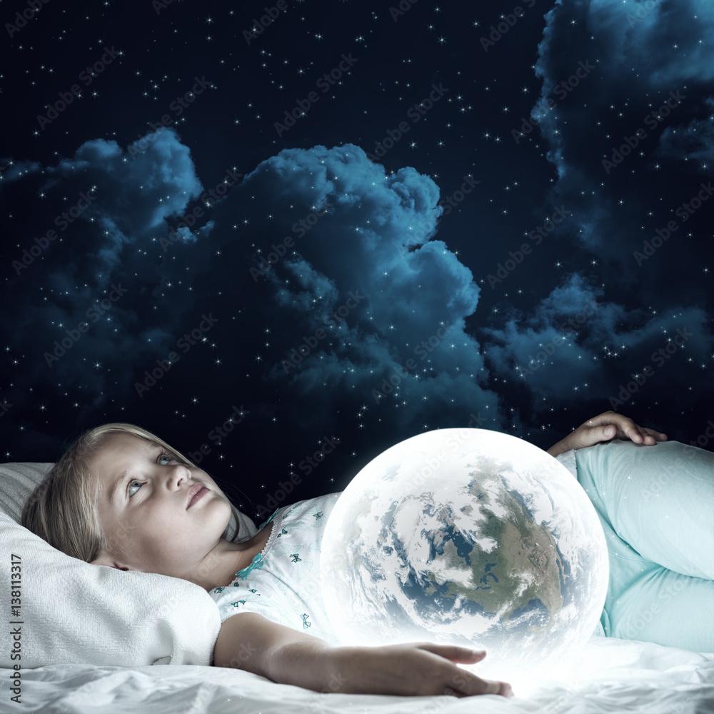 Girl in her bed and glowing globe