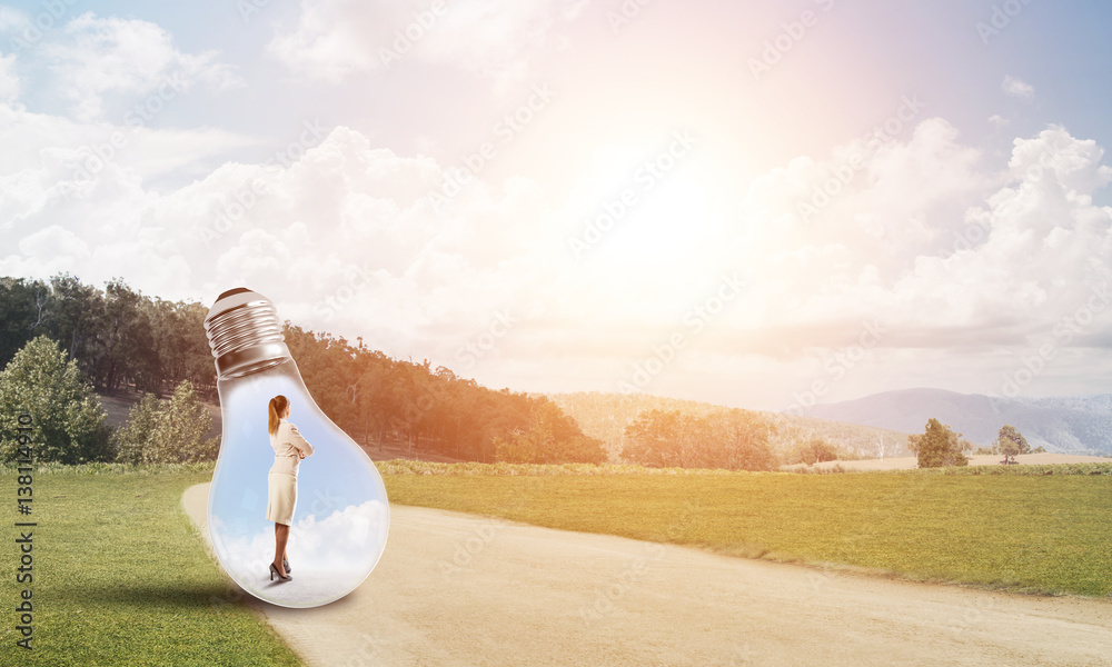 Businesswoman inside light bulb