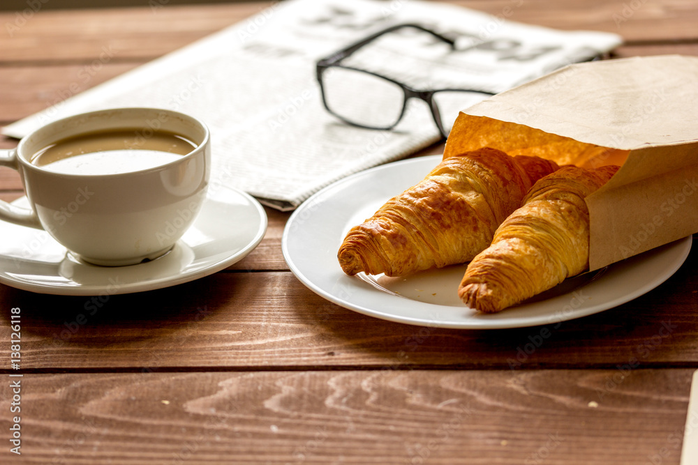 Businessman morning cup of coffee at home with newspaper