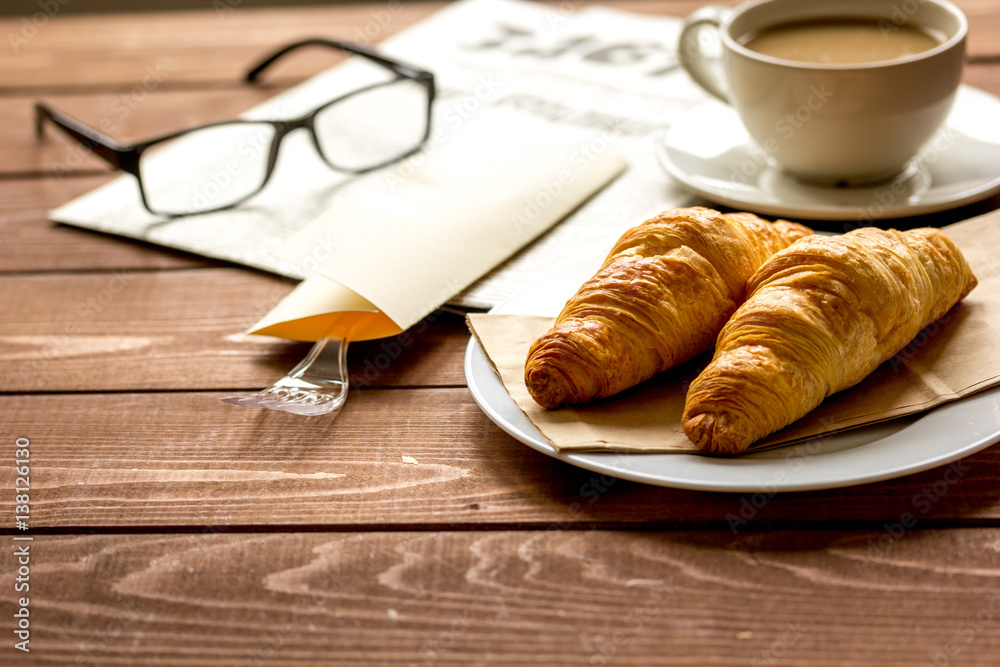 Businessman morning cup of coffee at home with newspaper