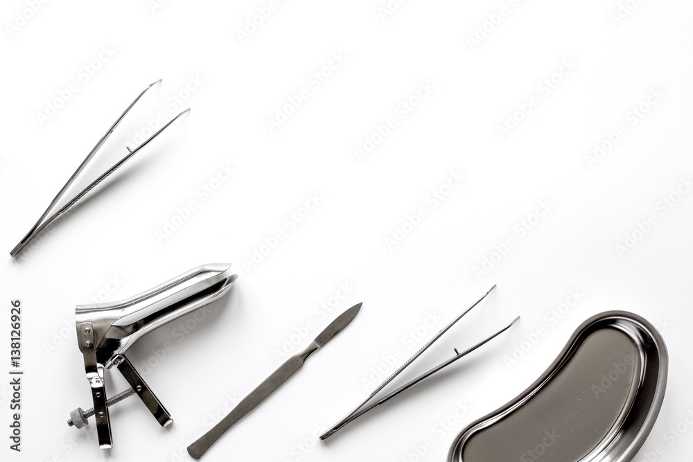 instruments of gynecologist on white background top view