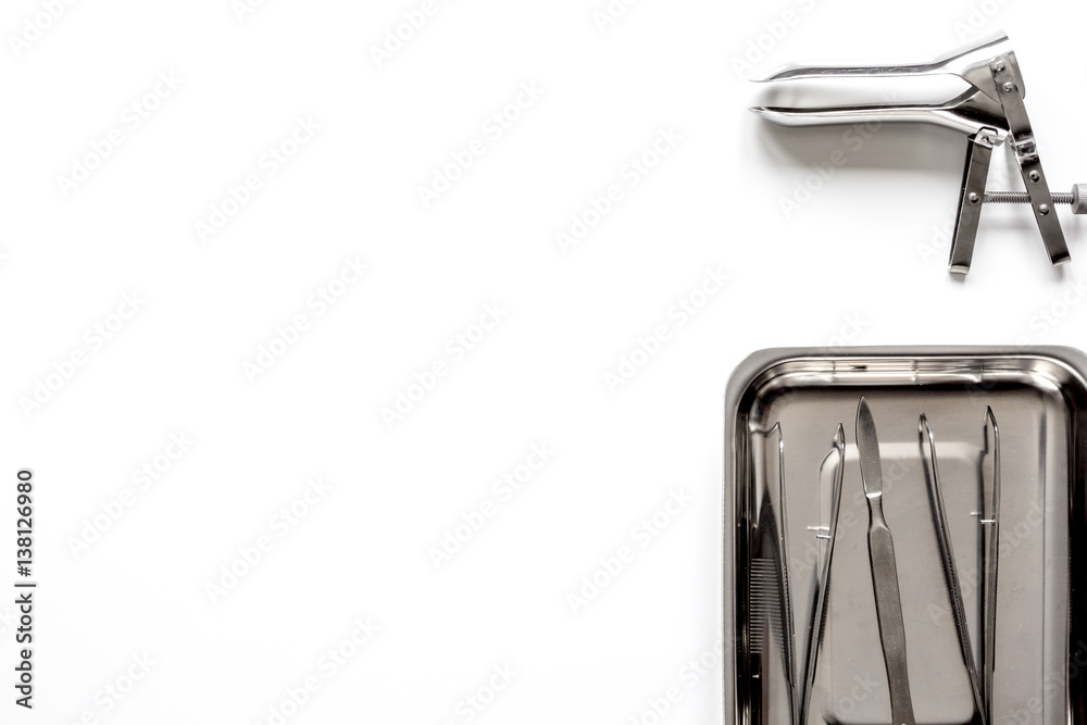 instruments of gynecologist on white background top view