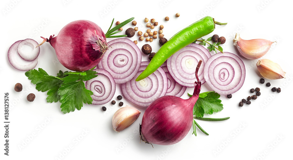 red onions, garlic and various spices on white background