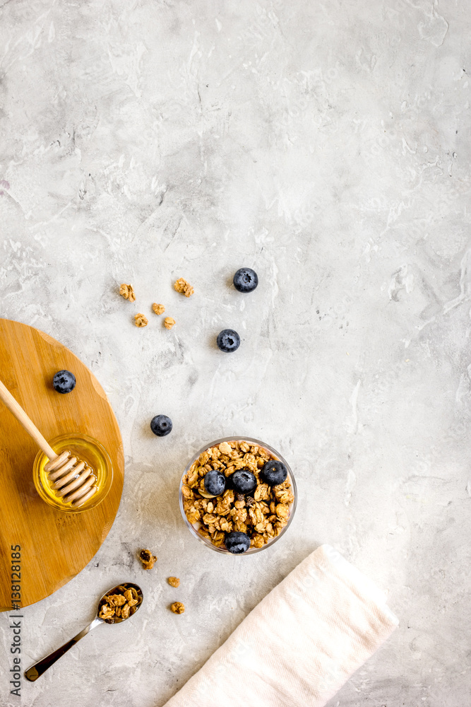 Oat flakes and berries granola glass on table background top view