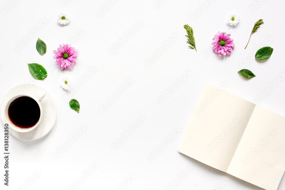 Coffee cup with flower petals and notebook top view mock-up