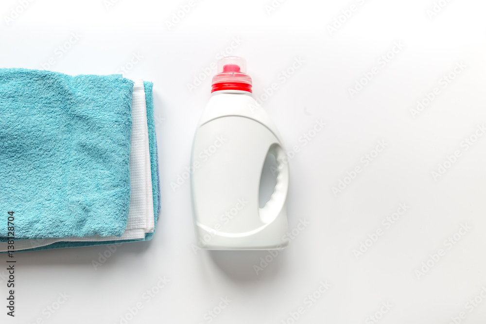 housekeeping set with towels and plastic bottles in laundry top view mock up