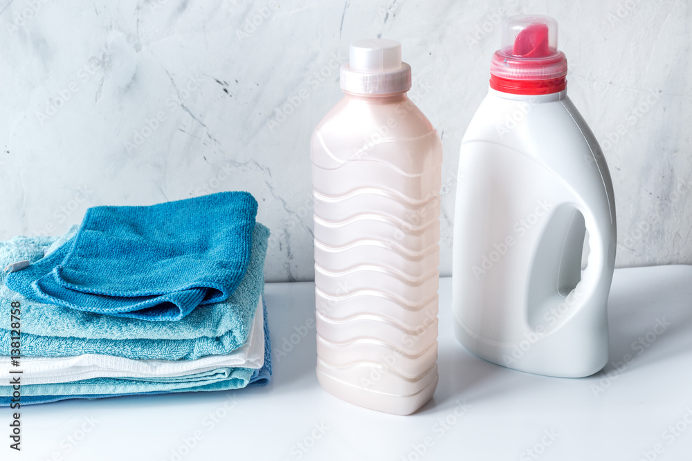 laundry set with towels and plastic bottels on white background