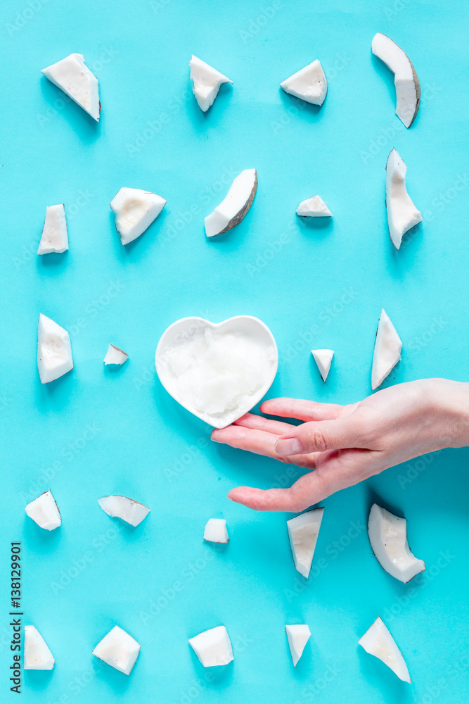 concept organic cosmetics with coconut on blue background top view