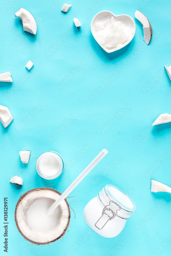 concept organic cosmetics with coconut on blue background top view