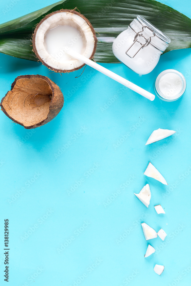 concept organic cosmetics with coconut on blue background top view