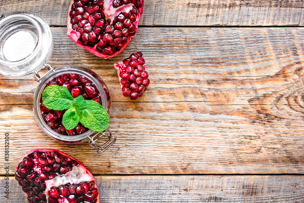 sliced pomegranate on wooden background top view