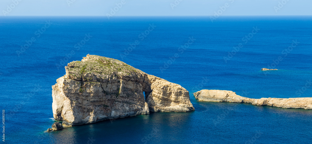 Gozo, Malta - The famous Fungus Rock on the island of Gozo on a beautiful hot summer day with crysta