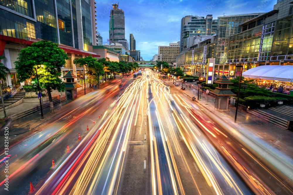 Busy street at dusk, full of car light streaks