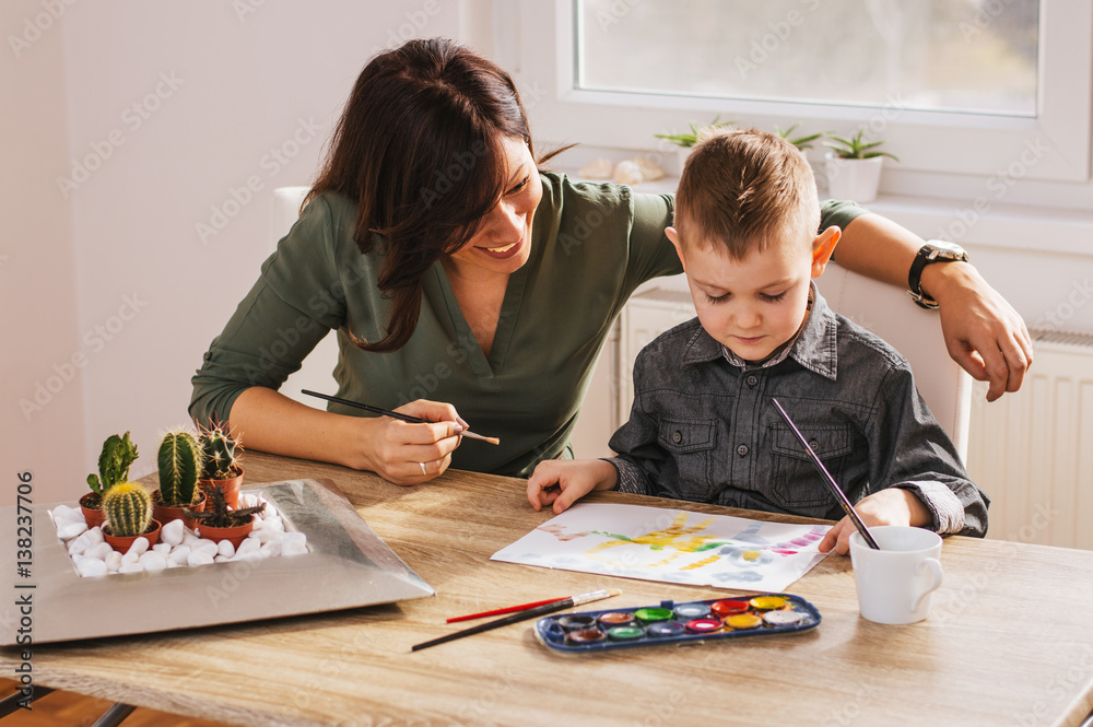 Child painting with mum