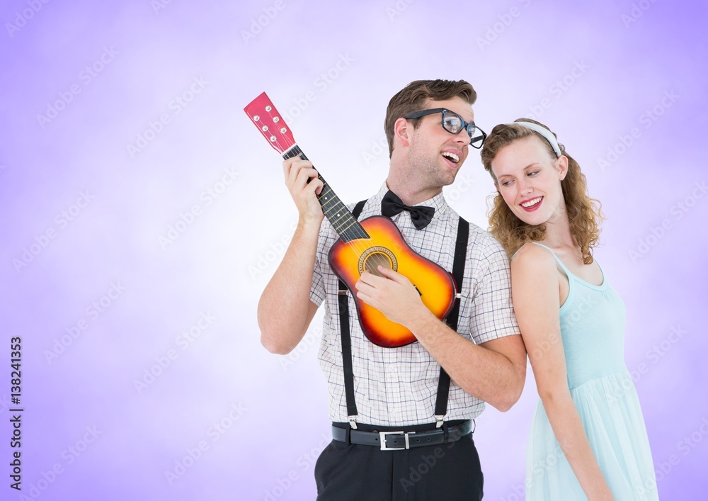 Happy couple playing guitar against a lavender background 