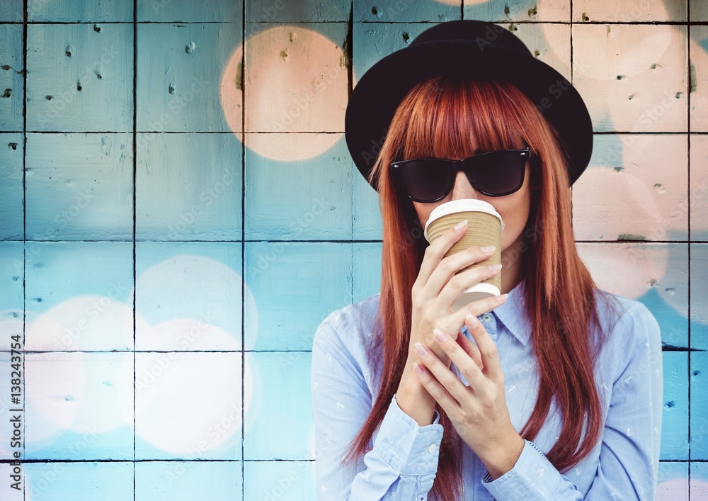 Woman with coffee against tiles with bokeh