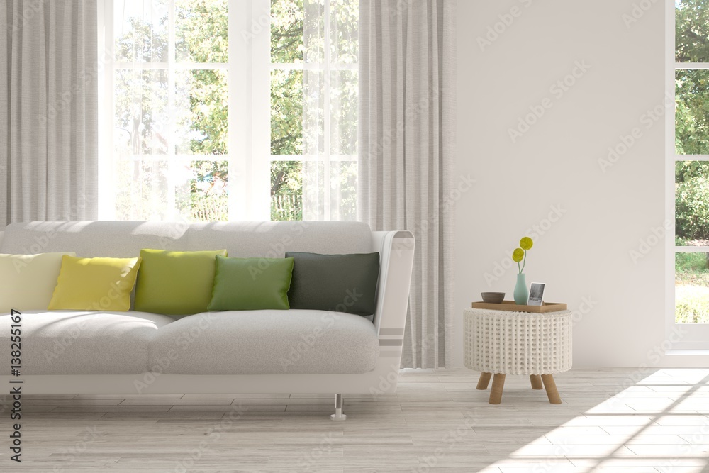 White room with sofa and green landscape in window. Scandinavian interior design