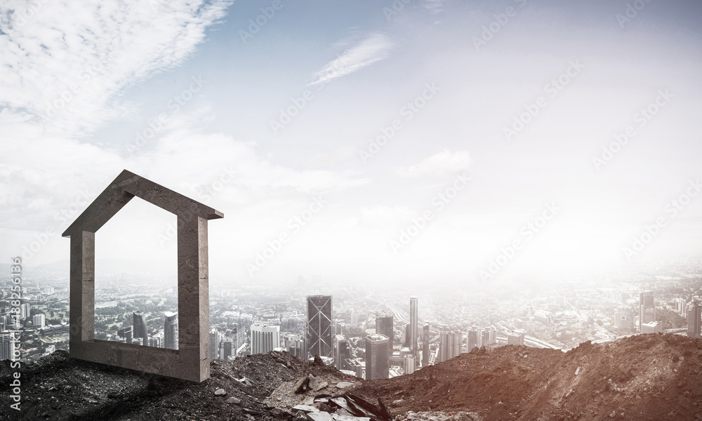 Conceptual image of concrete home sign on hill and natural lands