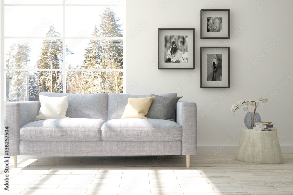 White room with sofa and winter landscape in window. Scandinavian interior design