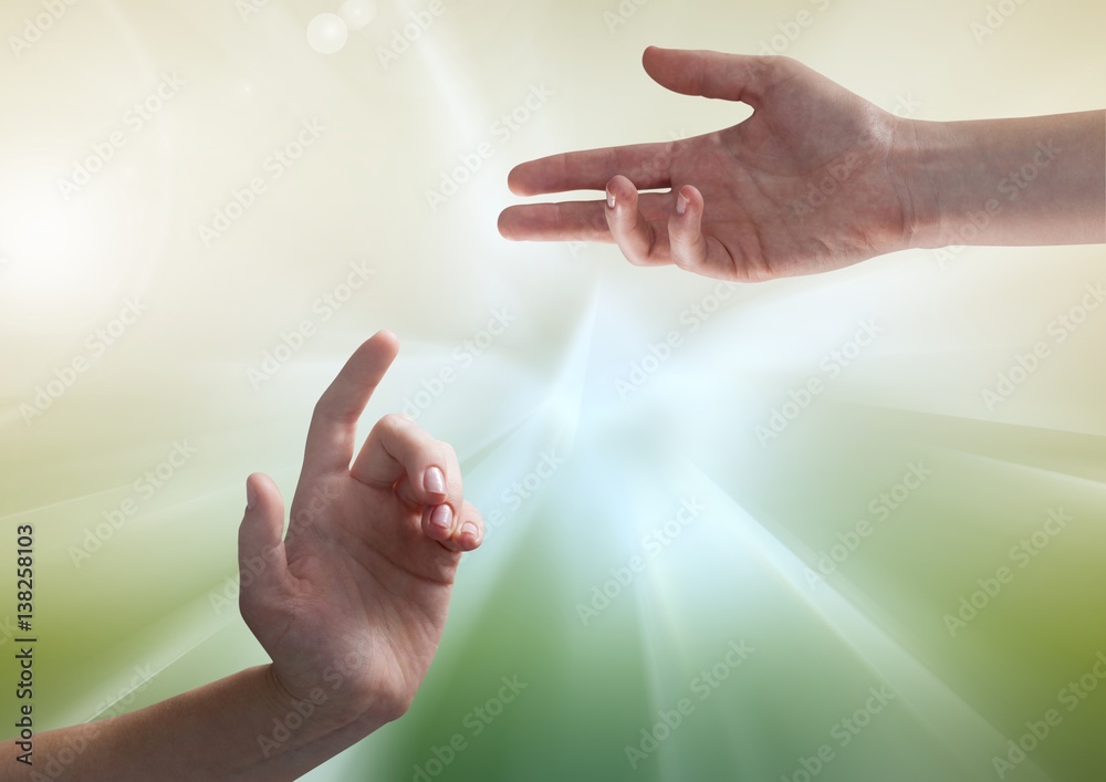 Composite image of Hands against illuminated green background