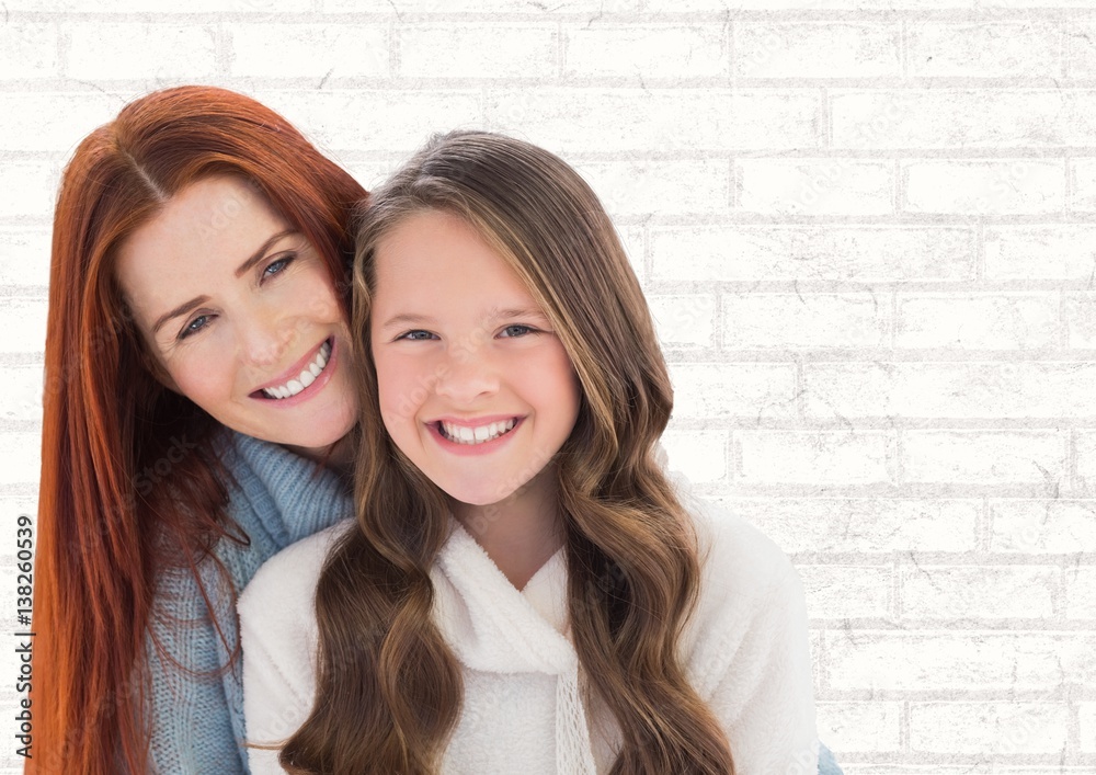 Mother and Daughter Smilling against a neutral background