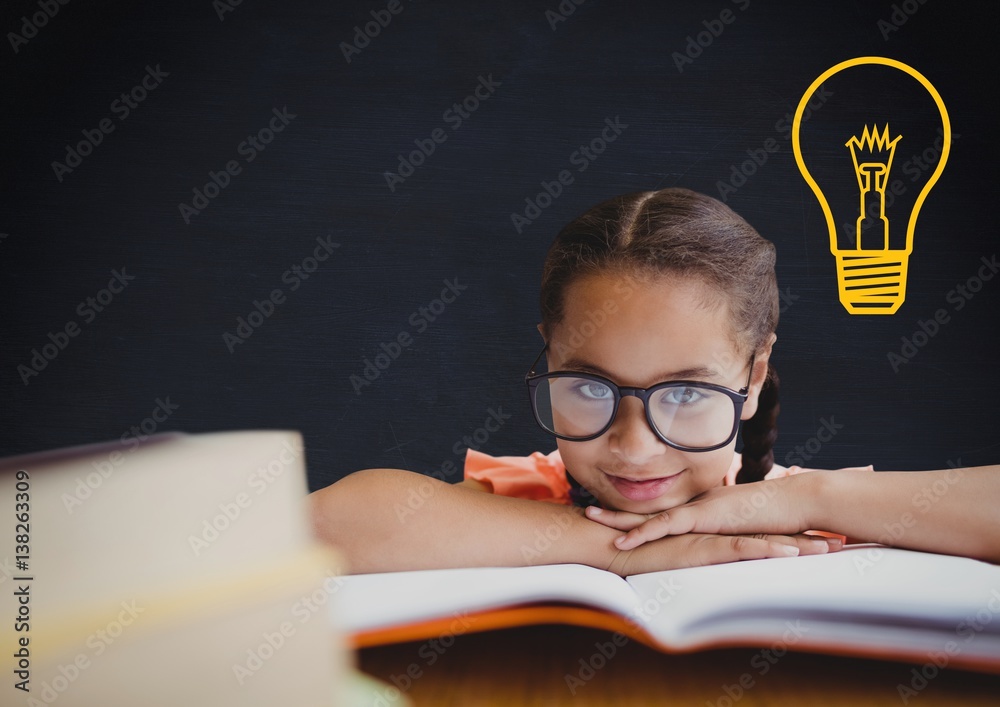 kid and blackboard with lightbulb against a black background 